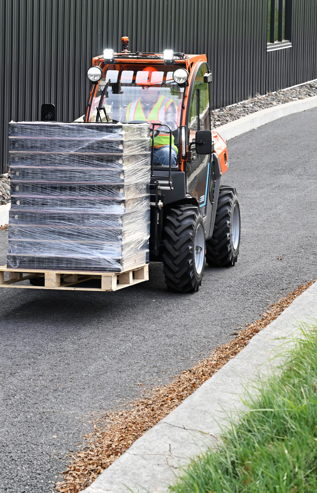 Image showing the JLG E313 Electric Telehandler hauling crates